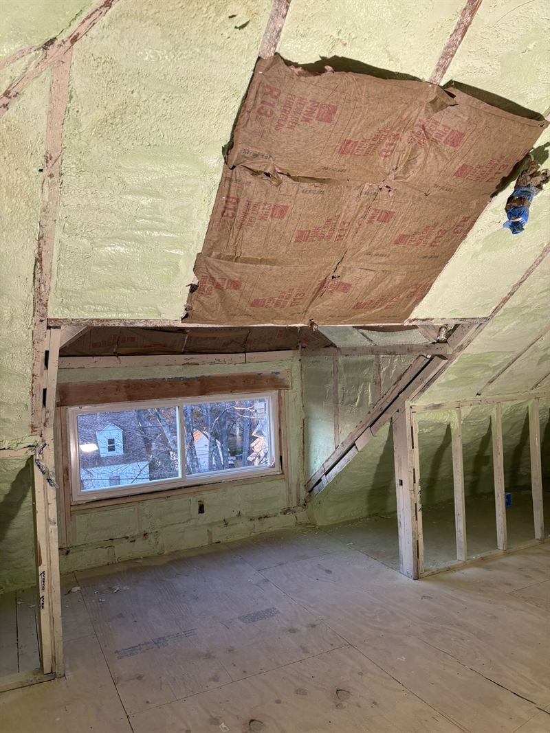 Attic roof deck and gable ends fully covered in spray foam insulation.