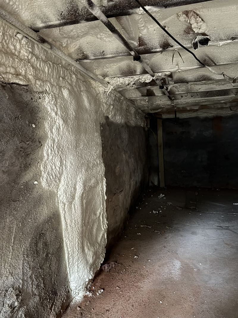 Basement rim joist band insulated with spray foam.